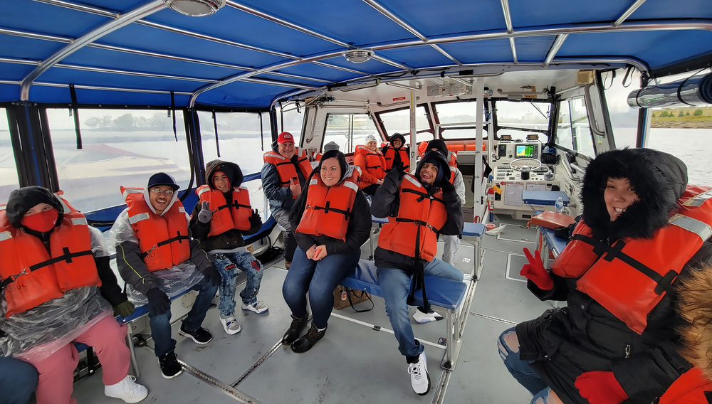 students in life vests on a boat
