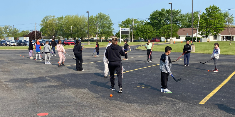 Students practice their hockey skills outside Martin Road Elementary