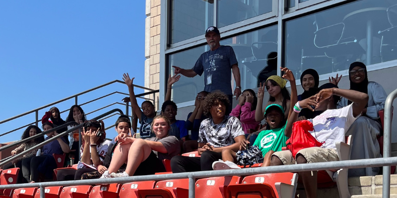 Students sit in the stands of Sahlen Field