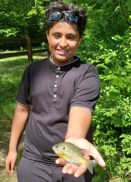 student holding a fish