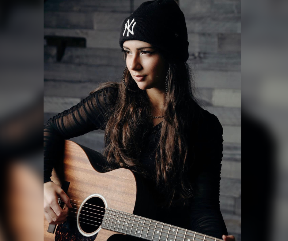 Emily Rodriguez poses with her guitar